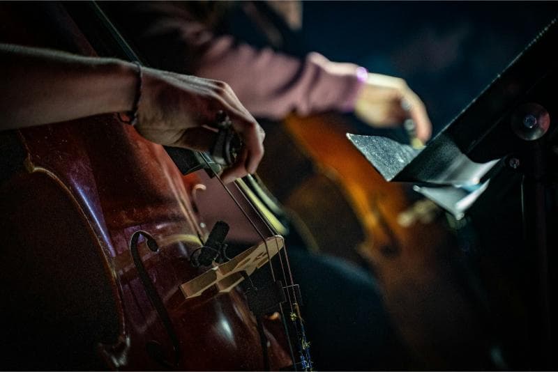 Close-up of a cello being played in an orchestra